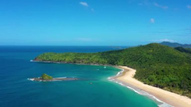 Aerial view of the white-sand beach of El Nido, Philippines. We can see mountains and palm trees forest in the background, perfect for summer travel in nature 4K