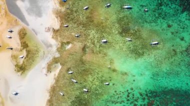 Filipinler, El Nido sahilinde tekneler. Su berrak ve turkuazdır. Yaz tatillerinde boş zaman aktivitesi için mükemmeldir. 4K insansız hava aracı ile hava manzarası.