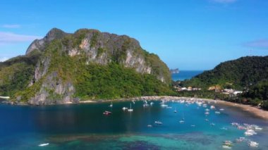 Harbor and boats on the island in of El Nido in Philippines. Paradise landscape, perfect for leisure activities in nature - aerial view with a drone 4K