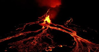 Close look on fagradalsfjall volcano erupting forming ash clouds and amazing lava flow. The lava running down like hot glowing rivers flowing over the steep sides of the volcano melting everything in its path.