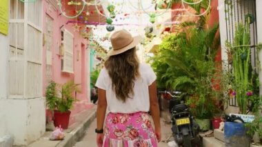 Beautiful girl walking in slow motion in old streets of cartagena.
