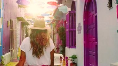 Following shot of a girl in cartagena streets.