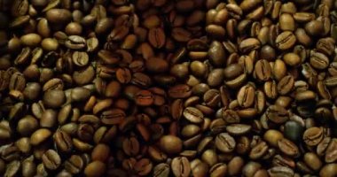 Dark brown coffee grounds spinning in mixing and cooling machine.
