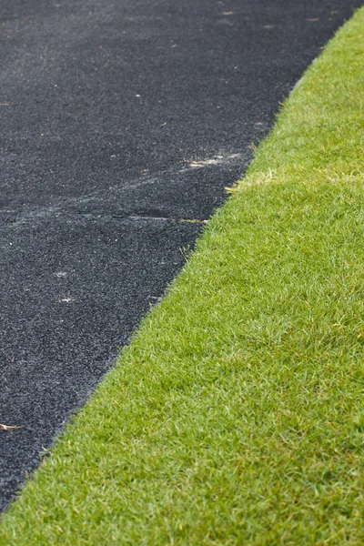 Asphalt with grass on the golf course — Stock Photo, Image
