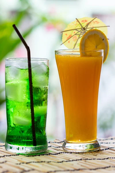 Green fruit soda and orange juice — Stock Photo, Image