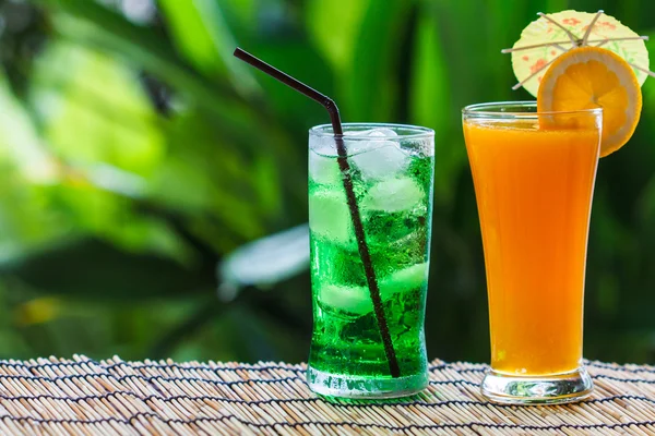 Green fruit soda and orange juice — Stock Photo, Image