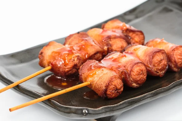 Fried sausage rolled with bacon — Stock Photo, Image