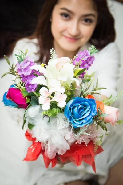 Asian Caucasian giving bouquet of colorful flowers — Stock Photo, Image