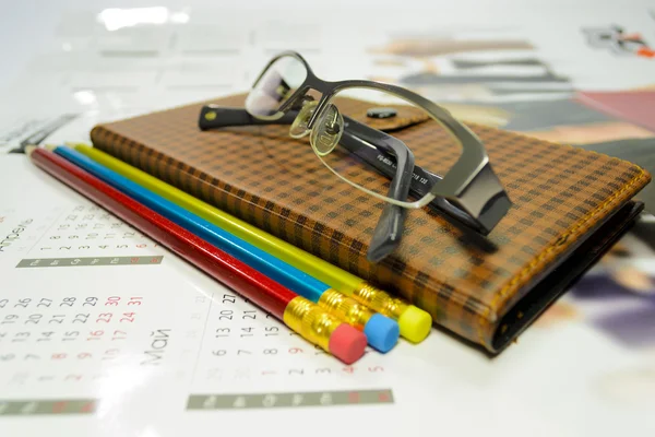 Notebook and pencil with glasses — Stock Photo, Image