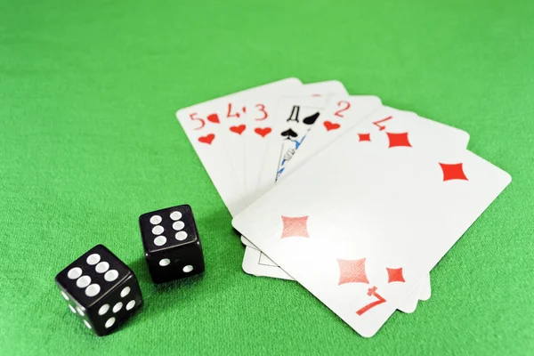 Playing cards, dice on cloth — Stock Photo, Image