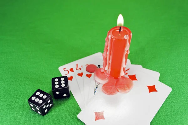 Playing cards, dice and a candle — Stock Photo, Image