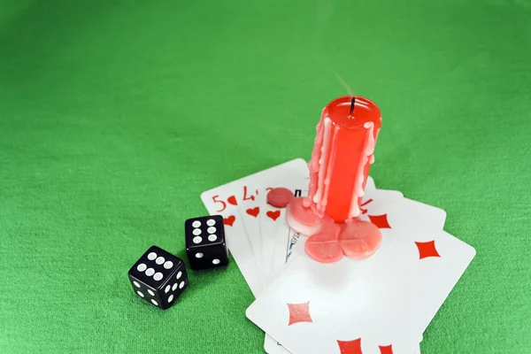 Playing cards, dice and a candle — Stock Photo, Image