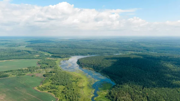 Russia, Ural. Takeoff over fields and forests. Swampy Pond. Shadows on the ground, Aerial View