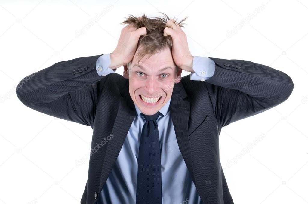 Stressed businessman pulling his hair