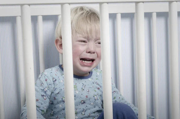 Crying boy in bed — Stock Photo, Image