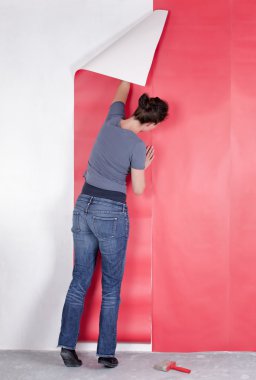 Woman hanging wallpaper clipart