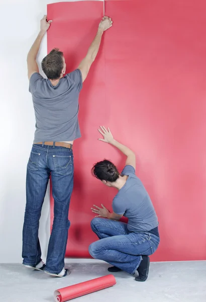 Man and wife wallpapering — Stock Photo, Image