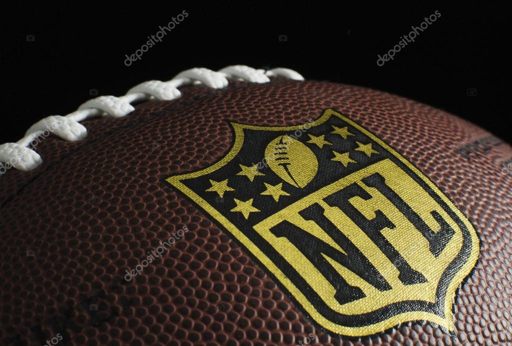 Close up of NFL logo on a football on black background