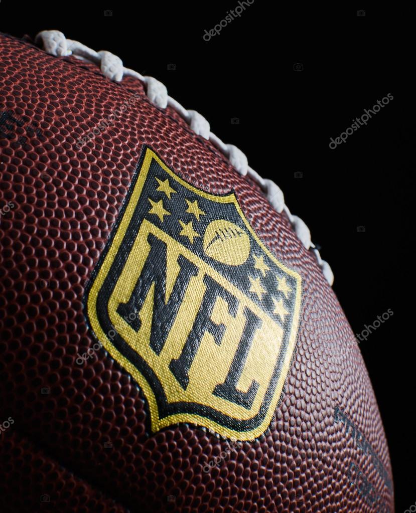 Close up of NFL logo on a football on black background