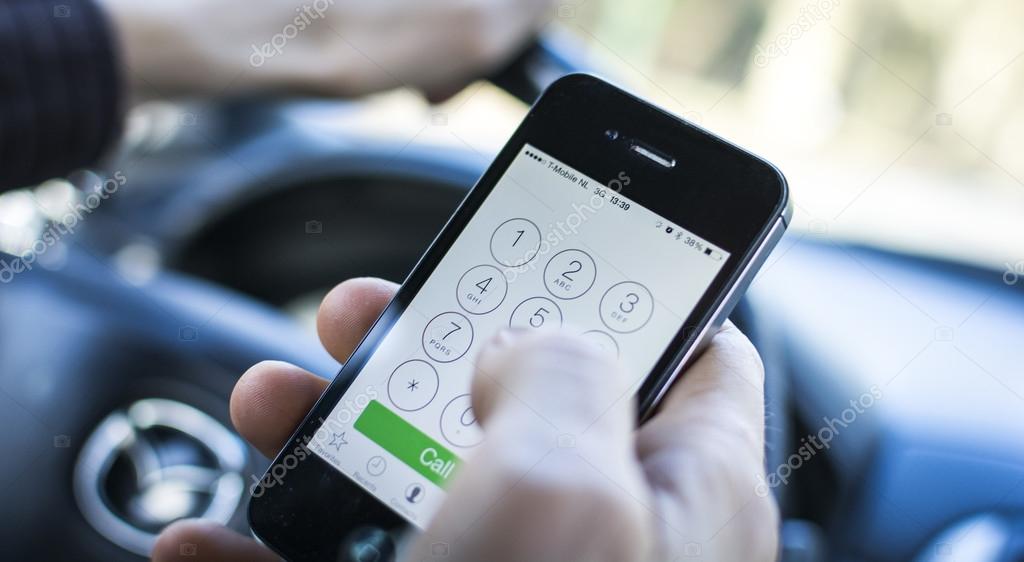 Calling behind the wheel, while driving a car. Dialing a number on Iphone.