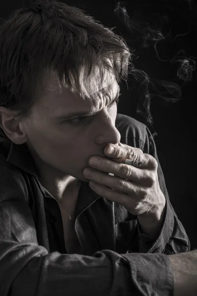 Depressed man smoking cigarette — Stock Photo, Image