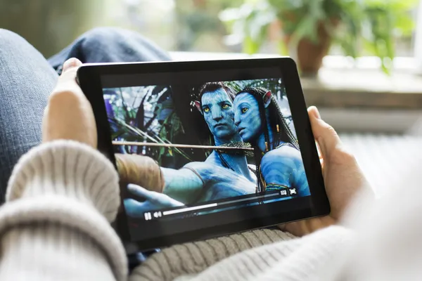 Watching movies online on iPad — Stock Photo, Image