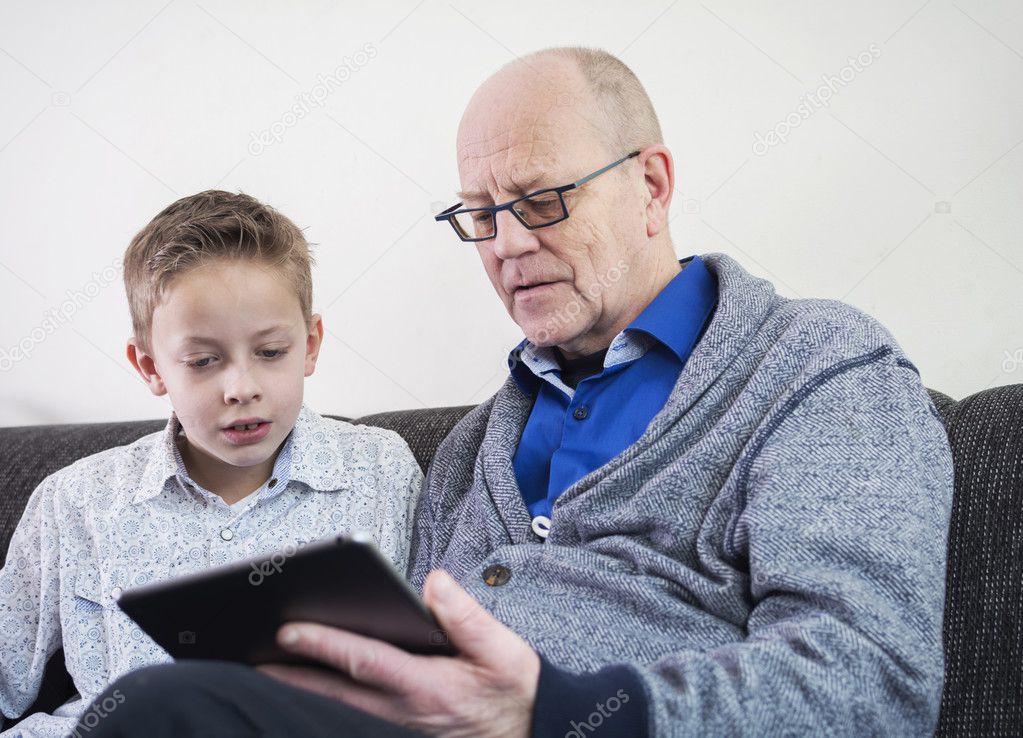 Boy and grandfather on tablet pc