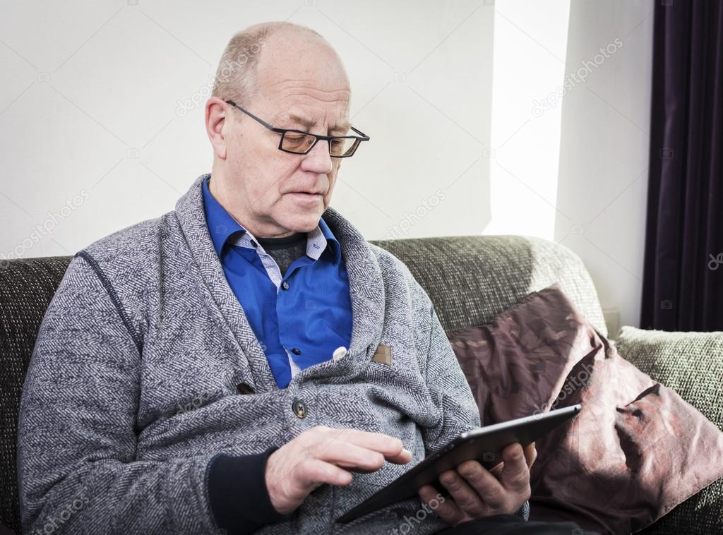 Old man on tablet pc
