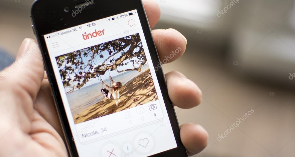 Showing tinder dating application on smartphone close up.