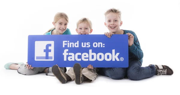 Kids holding Facebook like us sign — Stock Photo, Image