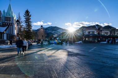 Banff, Alberta, Kanada - 23 Ocak 2022: Banff Bulvarı 'nda kış mevsimi. Yayalar covid-19 salgını sırasında karşıya geçiyorlar..