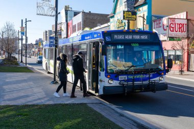 Niagara Şelalesi, Ontario, Kanada - 13 Aralık 2021: Niagara Şelalesi Transit otobüs durağı. Turistler şehir merkezinde otobüse biniyor..