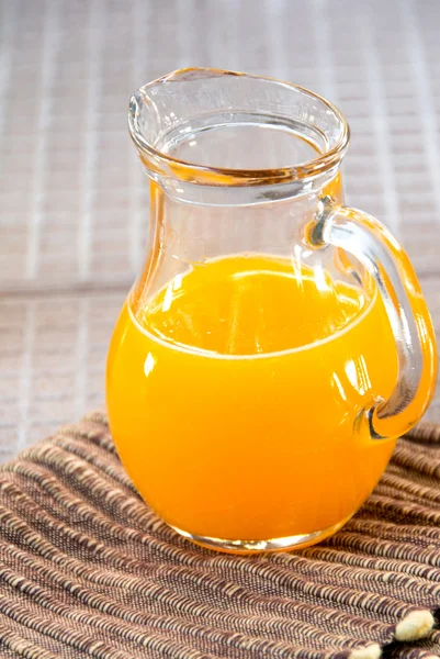 Orange juice in glass jug — Stock Photo, Image