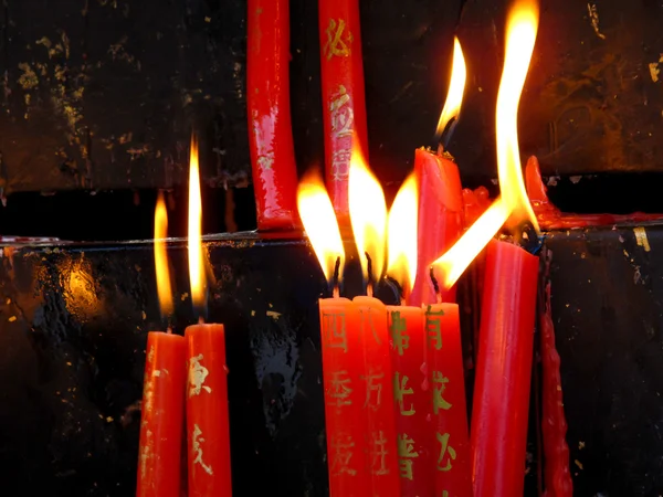 Burning red chinese candle in temple — Stock Photo, Image