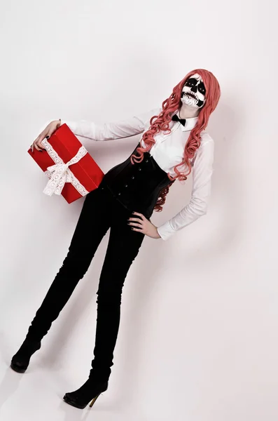 Young woman in mask skull face with gift. — Stock Photo, Image