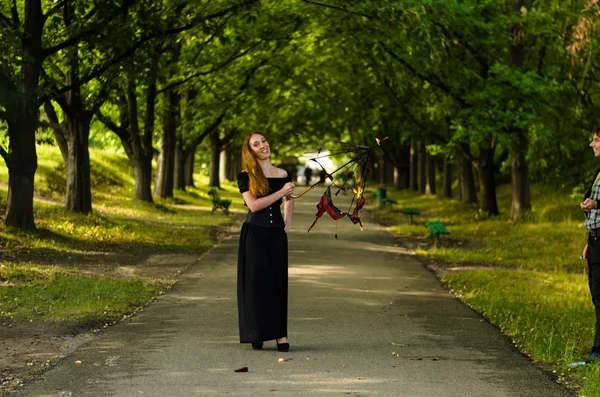 Girl in a black dress in the park — Stock Photo, Image