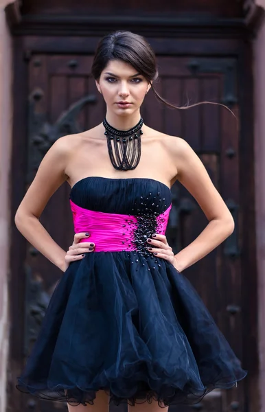 Girl posing near the door of Catholic church — Stock Photo, Image