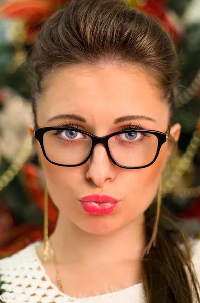 Girl in glasses hamming her lips — Stock Photo, Image