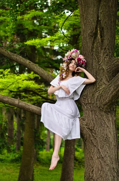 Κορίτσι με ένα στεφάνι στο δέντρο — Φωτογραφία Αρχείου