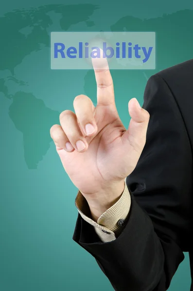 Businessman hand touching reliability button — Stock Photo, Image