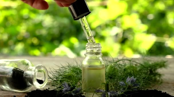 Black cumin oil in a bottle. Selective focus. — Stock Video