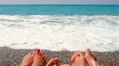 Family feet on the beach. Selective focus.