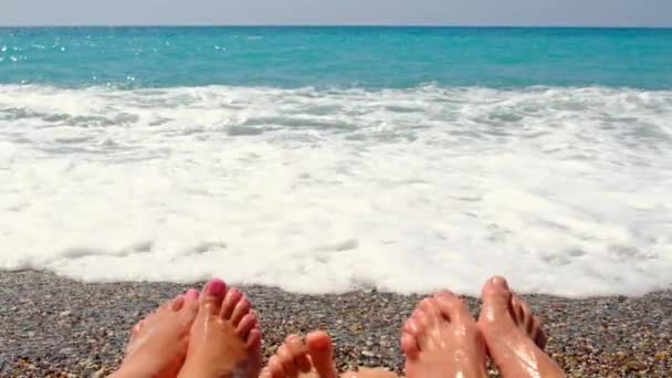 Family feet on the beach. Selective focus. — Wideo stockowe