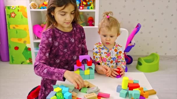 The child plays with toys in the room. Selective focus. — Stock Video