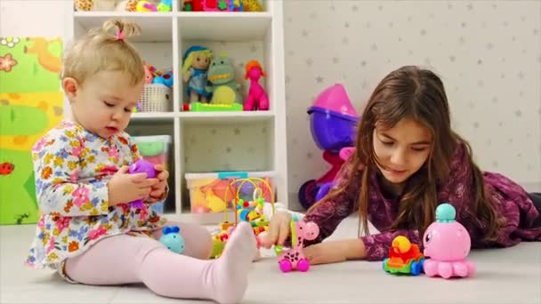 The child plays with toys in the room. Selective focus. — Stock Video