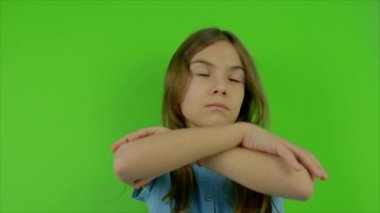 Çocuk yeşil arka plana hayır diyor. Seçici odak.