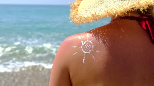 La donna sulla spiaggia spalma la crema solare. Focus selettivo. — Video Stock