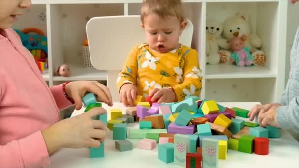 The child plays with toys in the room. Selective focus. — Stock Video