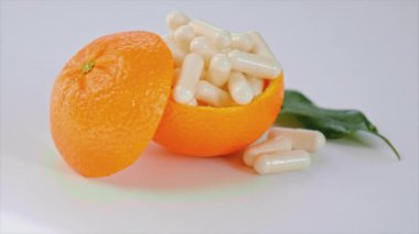 Beyaz arka planda portakallı C vitamini. Seçici odak.