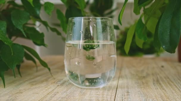 Vloeibare chlorofyl in een glas water. Selectieve focus. — Stockvideo